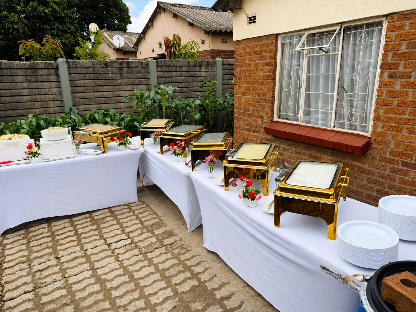 Complete outdoor buffet spread with gold chafing dishes